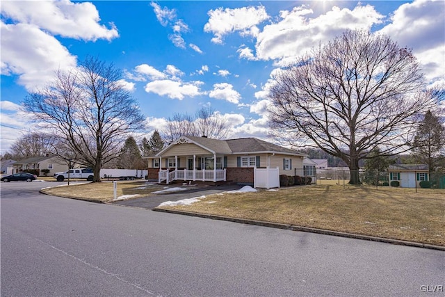 view of front of home featuring covered porch and a front yard