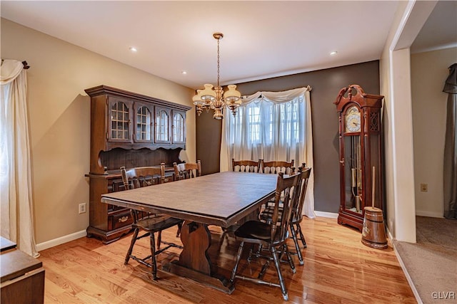 dining room featuring light hardwood / wood-style flooring and a chandelier