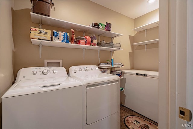 laundry area featuring tile patterned flooring and separate washer and dryer