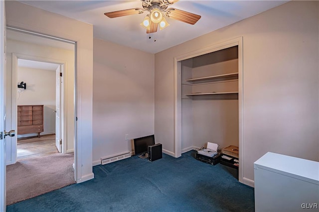 carpeted bedroom featuring baseboard heating, ceiling fan, and a closet