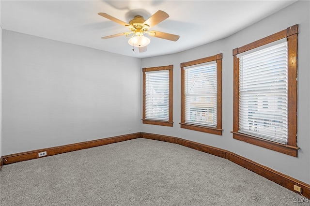 carpeted empty room featuring ceiling fan