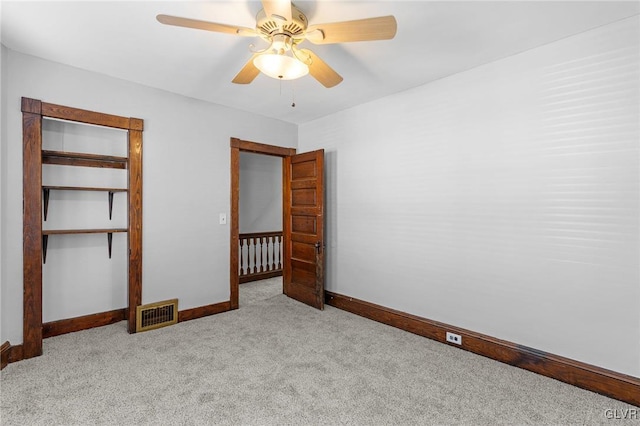 unfurnished bedroom with light carpet, ceiling fan, and a closet