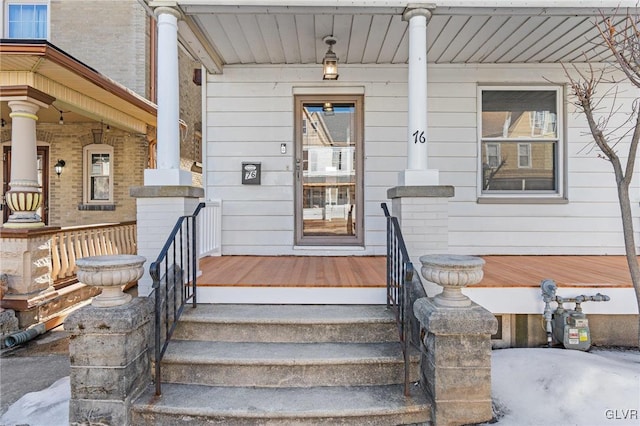 doorway to property featuring covered porch