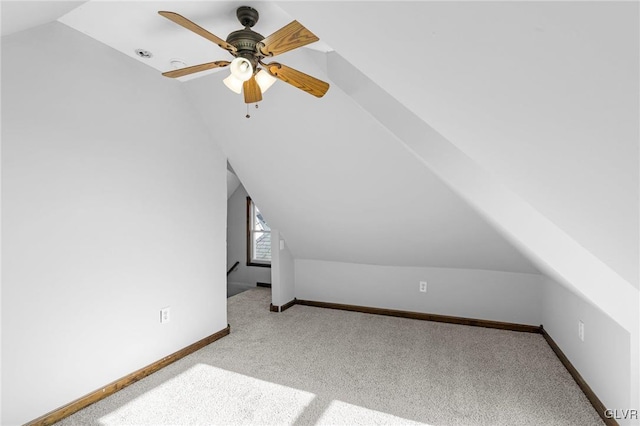 additional living space with light carpet, lofted ceiling, and ceiling fan