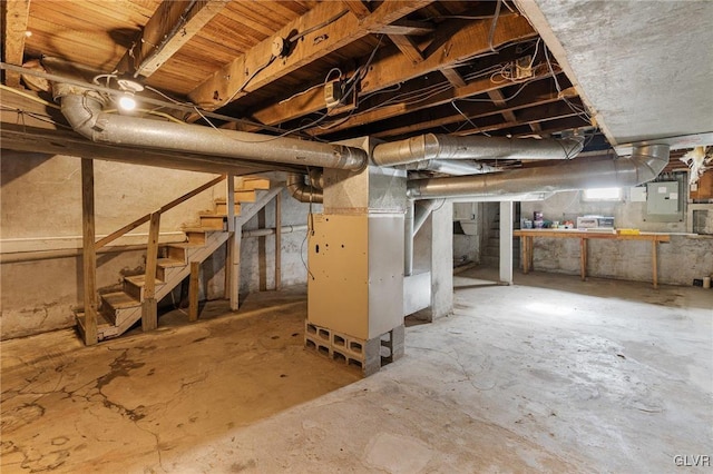 basement with electric panel and heating unit