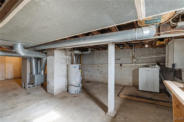 basement featuring heating unit, water heater, and washer / dryer