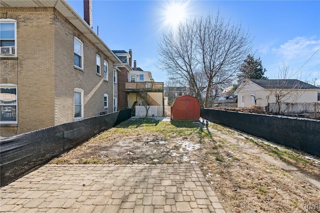 view of yard with a storage unit and a patio area