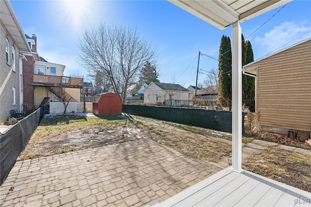 view of patio with a storage unit