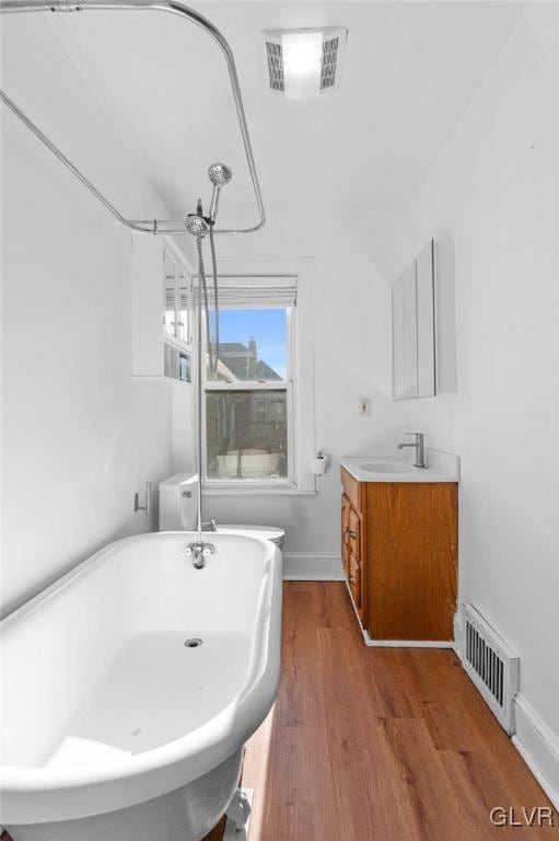 bathroom with a bath, wood-type flooring, and vanity