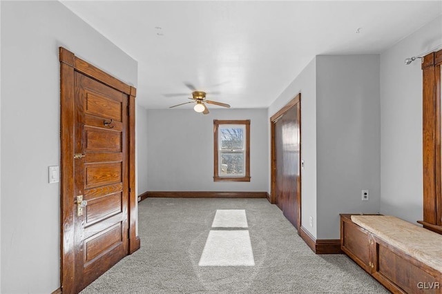 interior space with ceiling fan