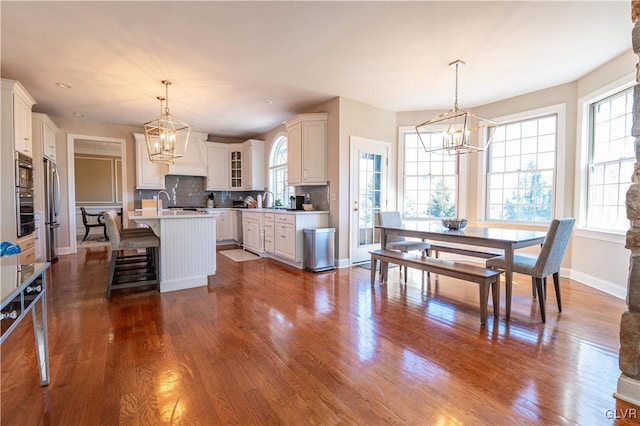 kitchen featuring an island with sink, an inviting chandelier, and hanging light fixtures