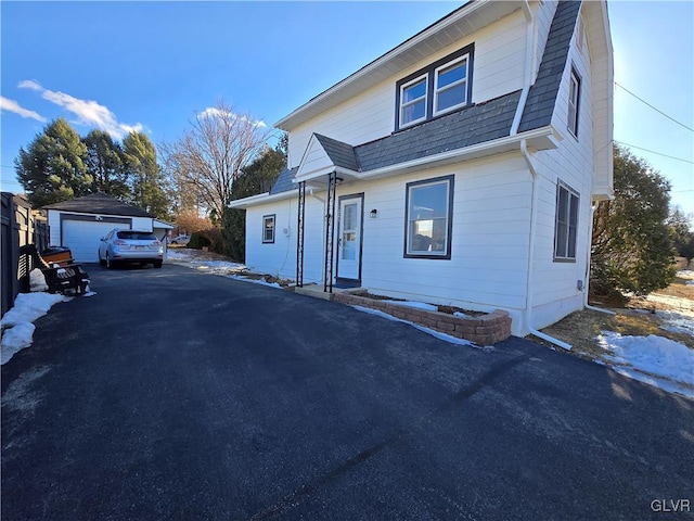 view of front of property featuring a garage and an outbuilding