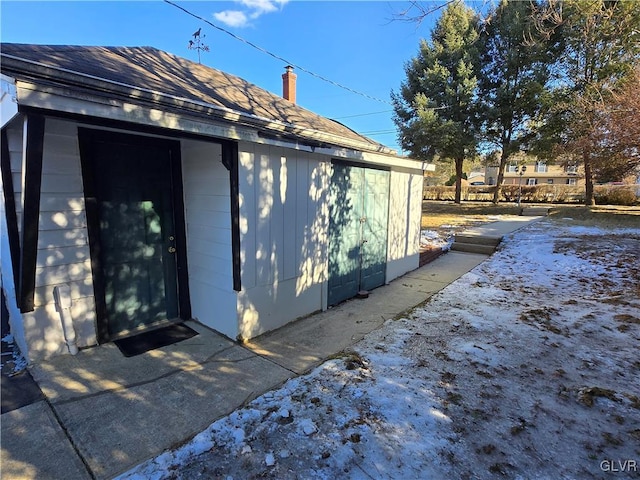 view of home's exterior with an outbuilding