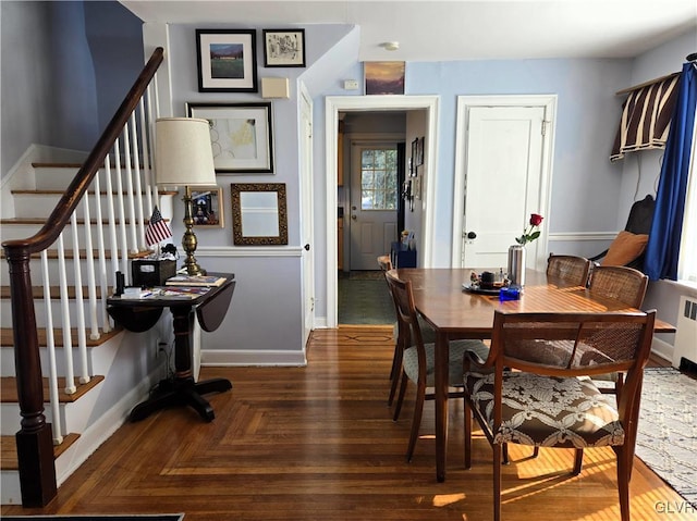 dining space featuring dark parquet floors