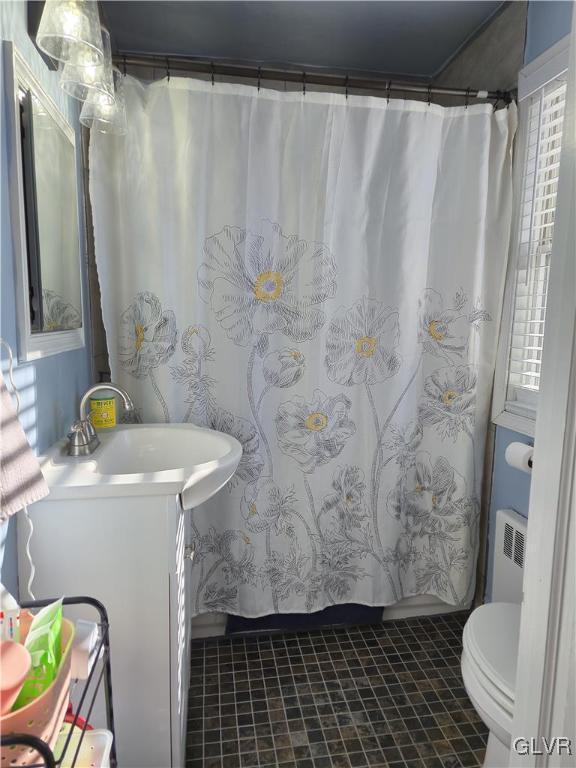 bathroom featuring tile patterned floors, radiator, toilet, vanity, and a shower with shower curtain