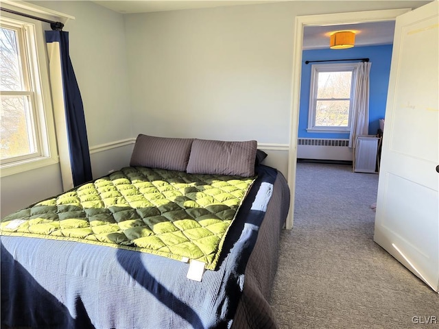 bedroom with radiator and carpet flooring