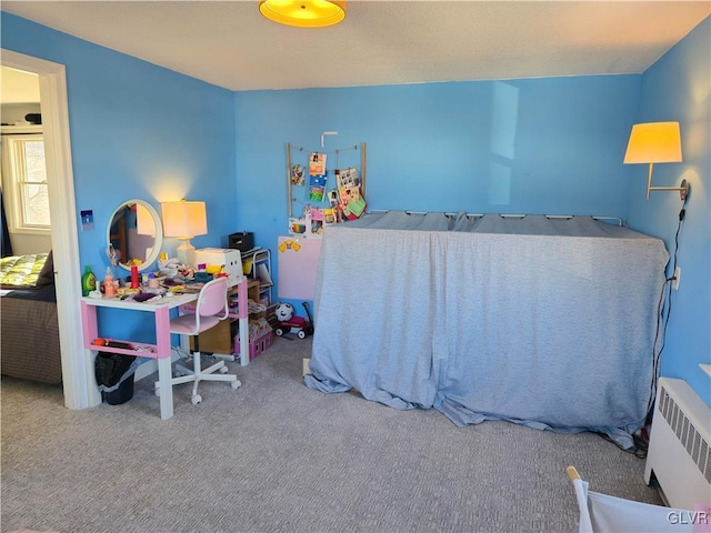 bedroom featuring carpet and radiator heating unit