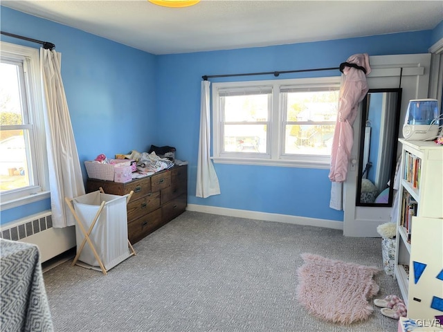 bedroom featuring carpet and radiator