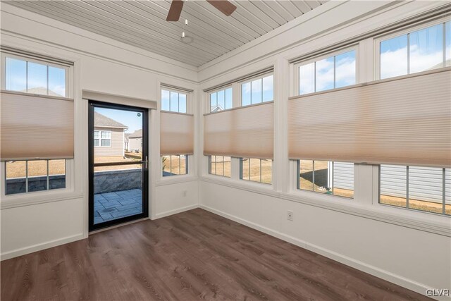 unfurnished sunroom featuring a wealth of natural light, wooden ceiling, and ceiling fan