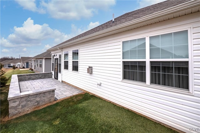 rear view of property featuring a patio area, a residential view, and a yard