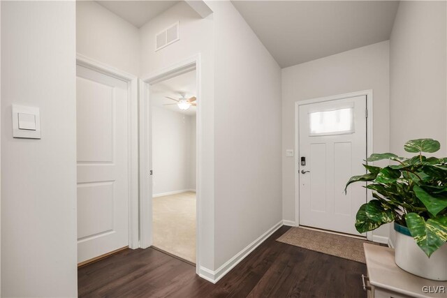 entryway featuring dark wood-type flooring, visible vents, and baseboards