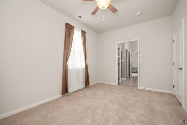 unfurnished room featuring light carpet, baseboards, visible vents, and ceiling fan