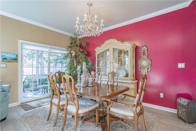 dining space with hardwood / wood-style floors, crown molding, and an inviting chandelier