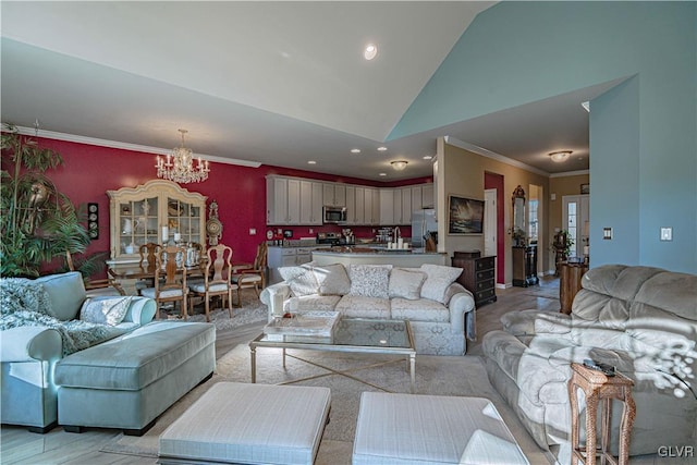 living room featuring high vaulted ceiling, sink, a chandelier, and crown molding