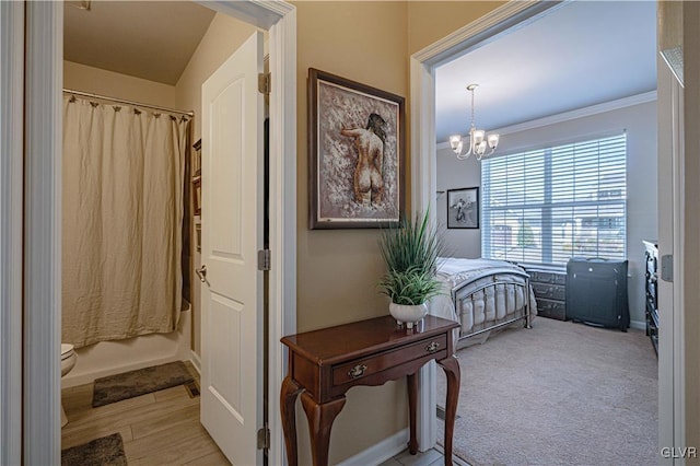 interior space with light carpet, an inviting chandelier, and crown molding