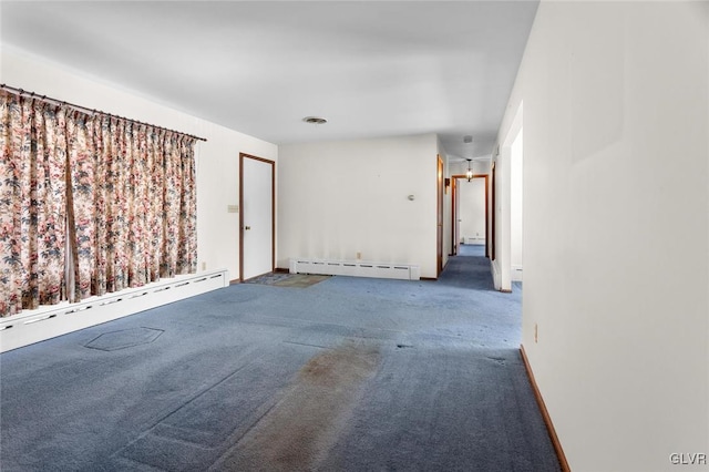 unfurnished room with carpet flooring and a baseboard heating unit