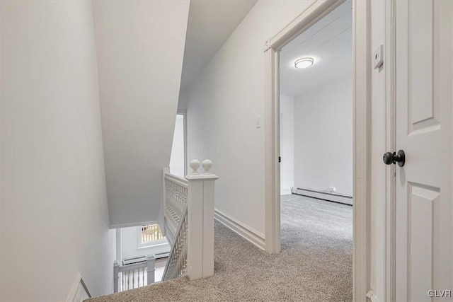 hall featuring a baseboard radiator, light colored carpet, and an upstairs landing