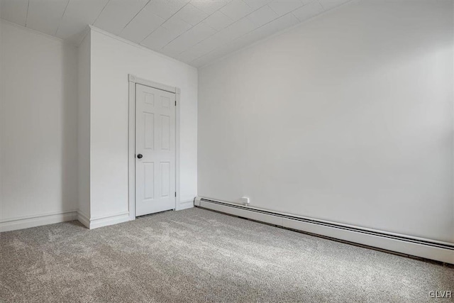 carpeted spare room featuring baseboard heating