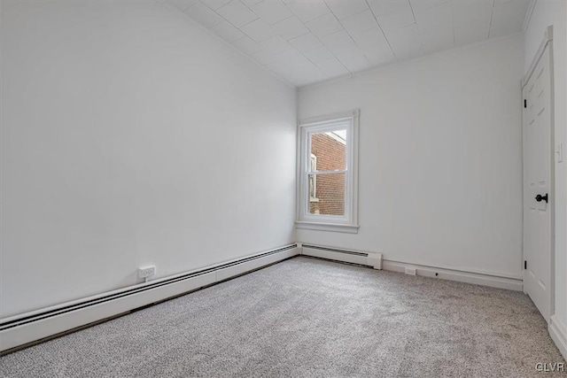 spare room with carpet and a baseboard radiator