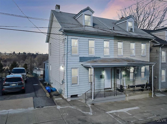 view of front of property featuring cooling unit and a porch