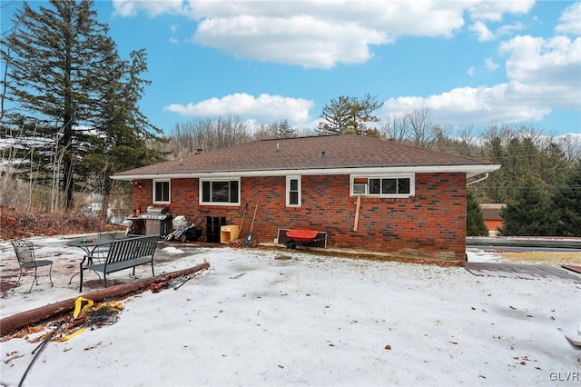 snow covered property featuring central AC unit