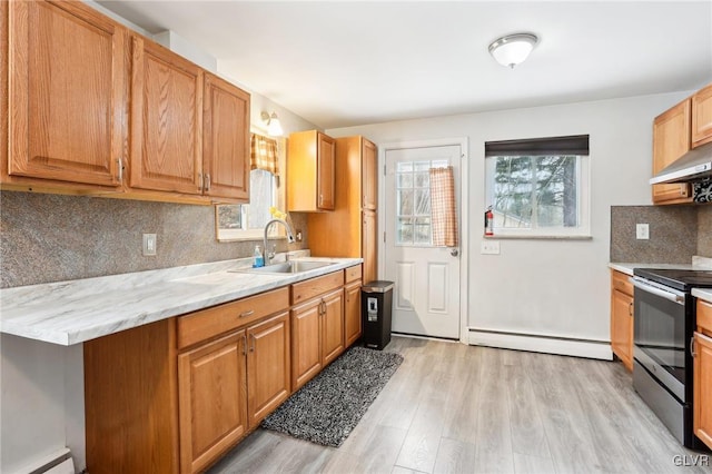 kitchen with light wood-type flooring, baseboard heating, sink, and stainless steel electric stove