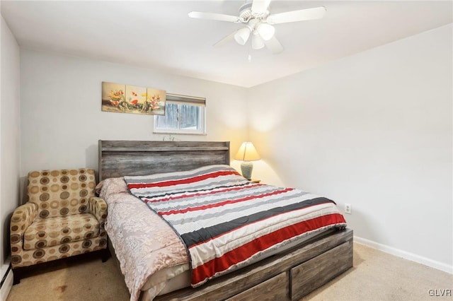 carpeted bedroom featuring a baseboard heating unit and ceiling fan