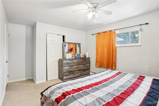 carpeted bedroom featuring ceiling fan and a closet