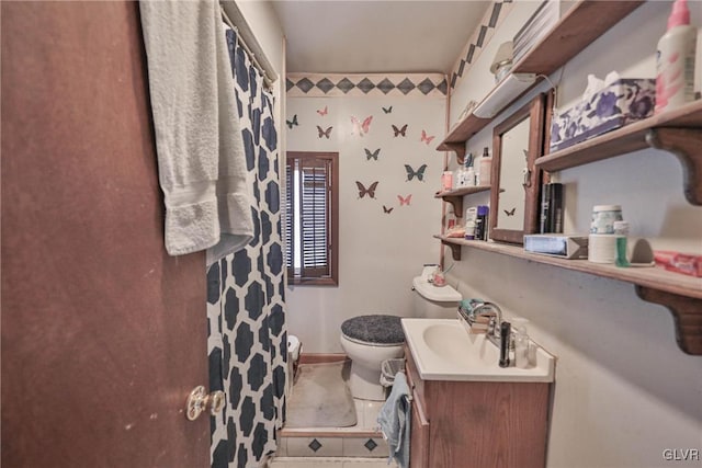 bathroom featuring toilet, tile patterned flooring, and vanity