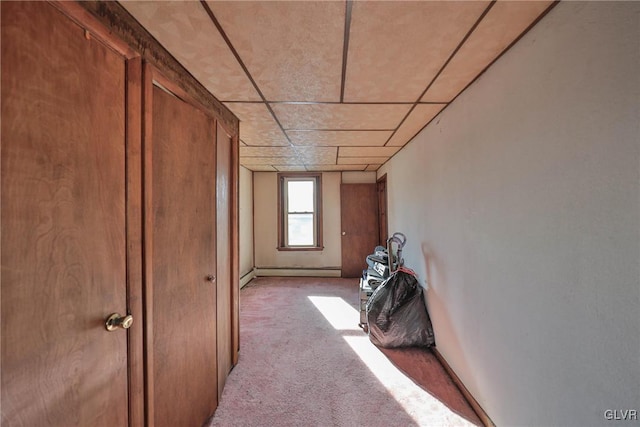 hall with a baseboard radiator and light colored carpet