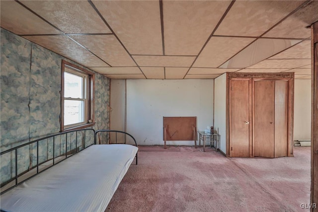 bedroom featuring baseboard heating and light carpet