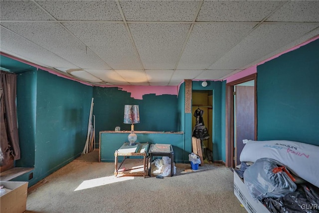 bedroom with a drop ceiling and carpet flooring