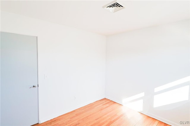 unfurnished room with wood-type flooring