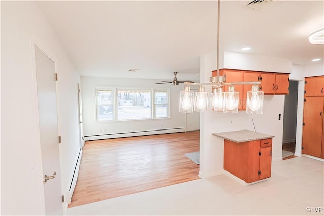 kitchen with light hardwood / wood-style floors, ceiling fan, kitchen peninsula, and a baseboard radiator