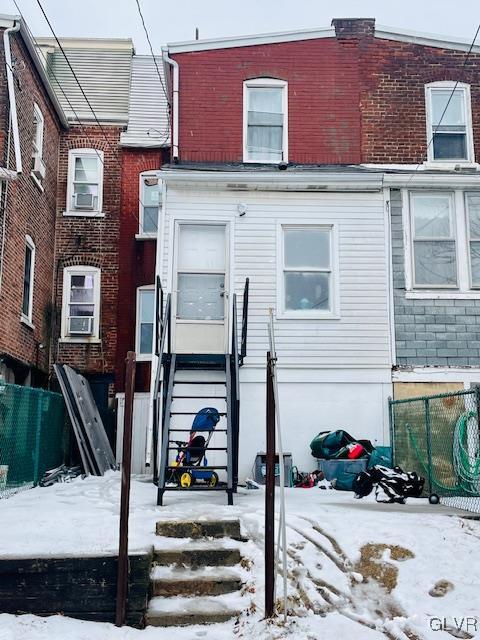 view of snow covered rear of property