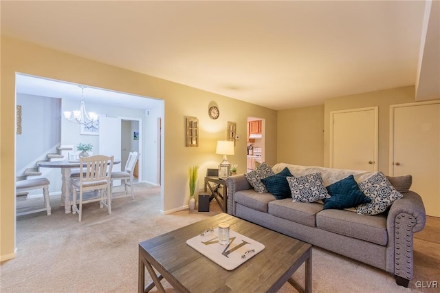 carpeted living room with a notable chandelier