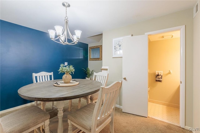 dining room featuring light carpet and an inviting chandelier