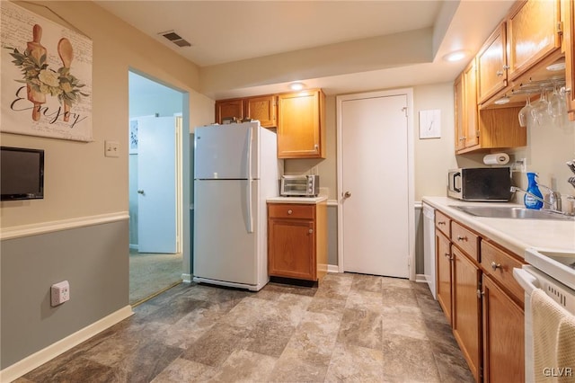 kitchen featuring sink and white appliances