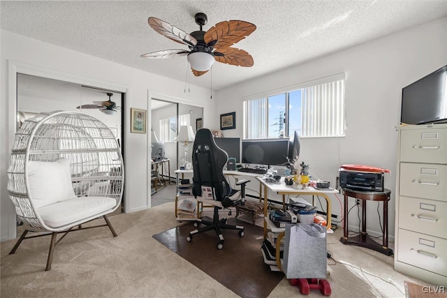 office with light colored carpet, ceiling fan, and a textured ceiling