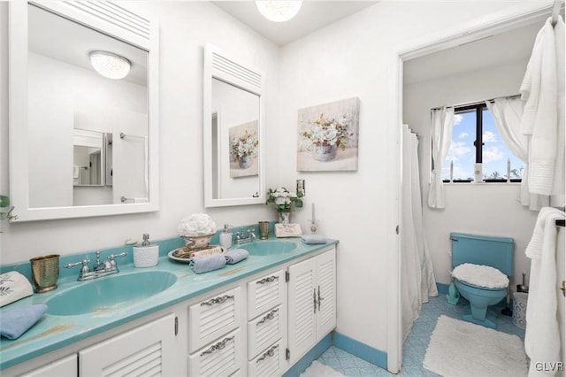 full bath featuring a sink, baseboards, and double vanity